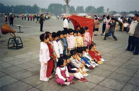 Children in China line up to be phtographed by tourists, travelers and families